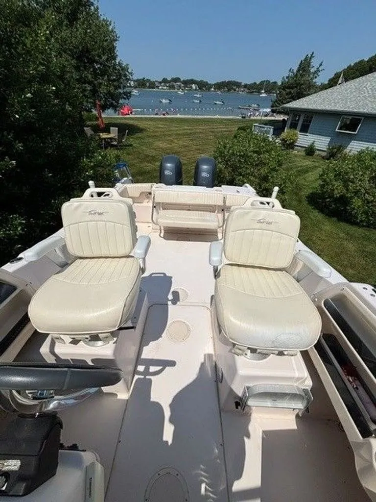 Slide: The Image of The image shows the deck of a 2007 Grady-White Journey boat with two beige seats. - 10