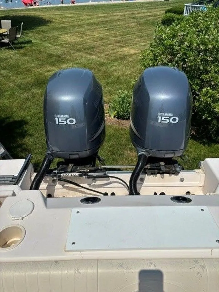 Slide: The Image of Two Yamaha 150 outboard motors on a Grady-White Journey boat, parked outdoors. - 18