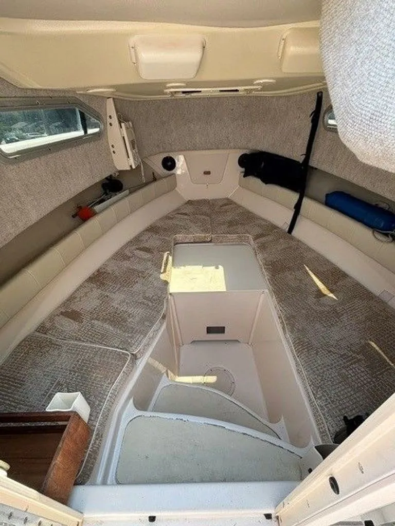 Slide: The Image of Interior of a 2007 Grady-White Journey with cushioned seating and storage space. - 15