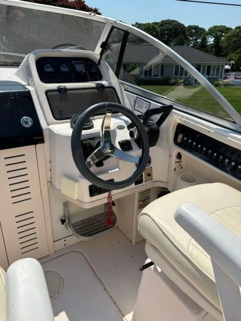 Slide: The Image of The image shows the cockpit of a 2007 Grady-White Journey boat with a modern helm. - 13