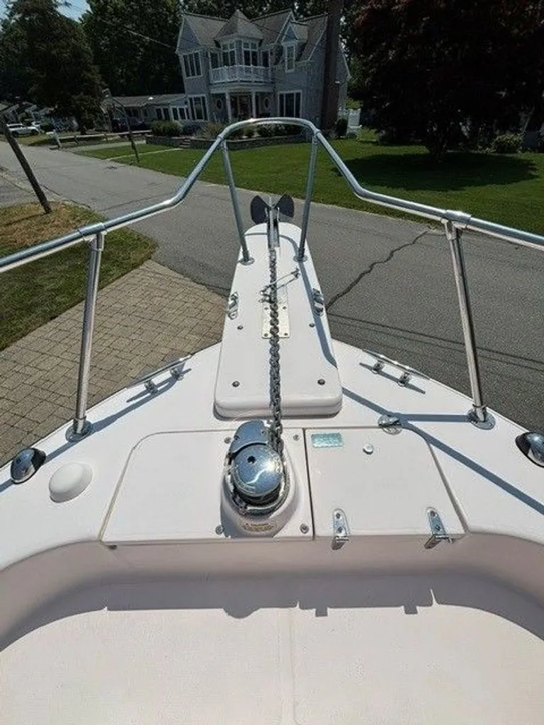 Slide: The Image of The image shows the bow deck of a 2007 Grady-White Journey boat parked on a street. - 4
