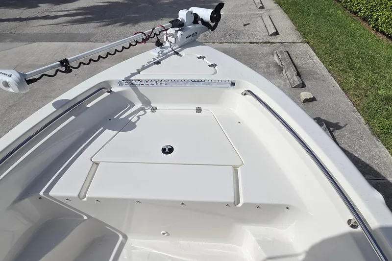 Slide: The Image of 2022 Key West 189 FS boat bow with trolling motor and storage compartment. - 10