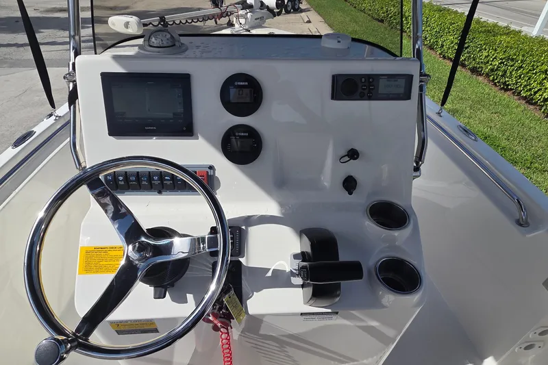 Slide: The Image of 2022 Key West 189 FS boat dashboard with steering wheel, gauges, and navigation system. - 18