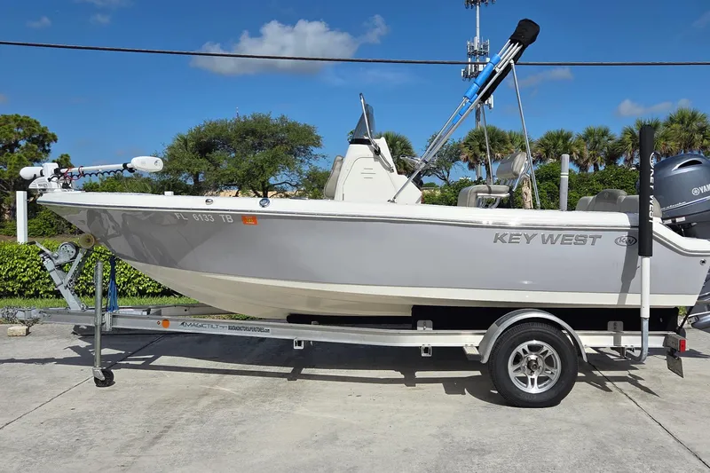 The Image of 2022 Key West 189 FS boat on trailer, parked outdoors under clear sky. - 0