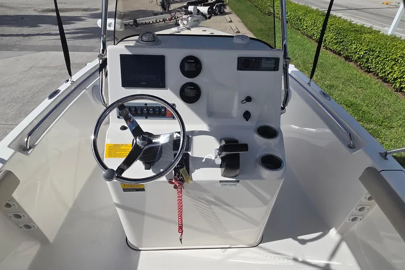 Slide: The Image of 2022 Key West 189 FS boat console with steering wheel and controls. - 4