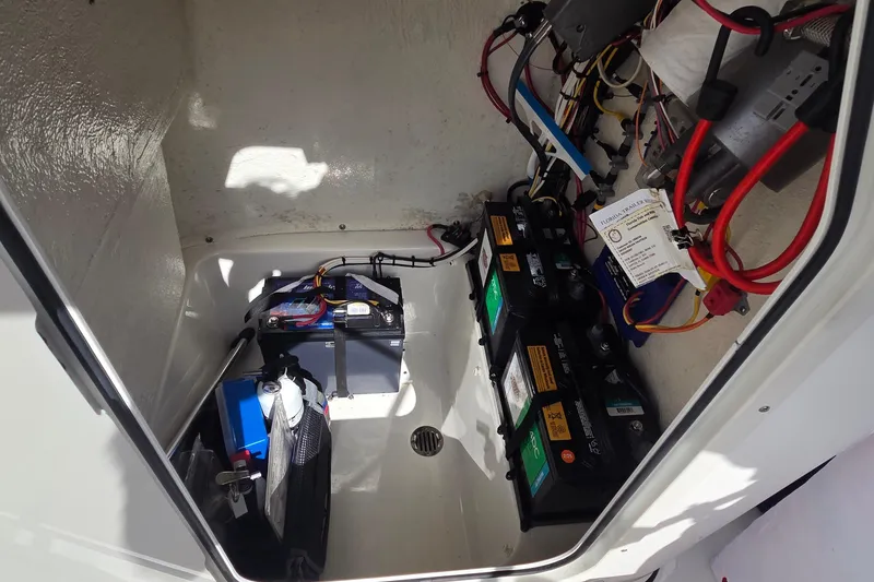 Slide: The Image of 2022 Key West 189 FS boat battery compartment with wiring and components. - 12