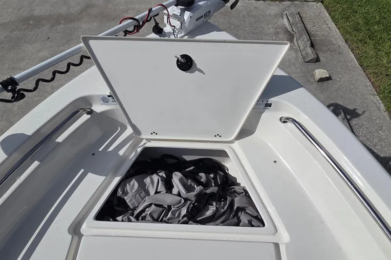 Slide: The Image of 2022 Key West 189 FS boat with open storage compartment and trolling motor. - 11
