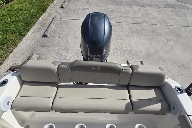 Slide: The Image of 2022 Key West 189 FS boat with cushioned seating and outboard motor. - 6