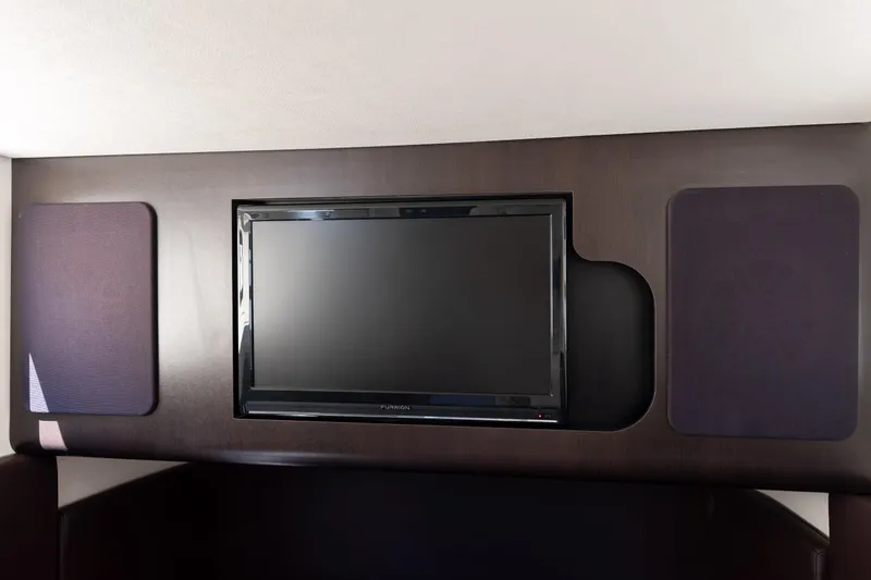 Slide: The Image of Flat-screen TV and speakers in 2019 Scout 355 LXF boat interior. - 40