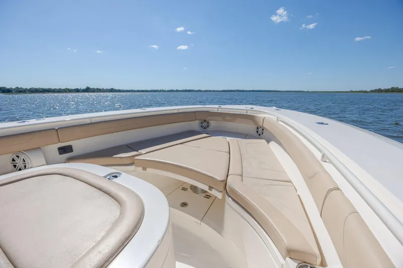 Slide: The Image of 2019 Scout 355 LXF boat interior with luxurious seating on a sunny day. - 29