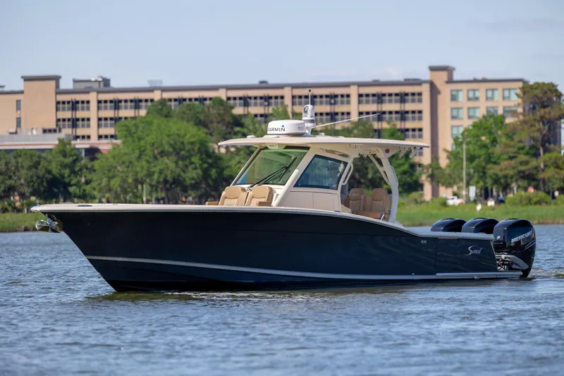 Slide: The Image of 2019 Scout 355 LXF boat on water, featuring sleek design and powerful engines. - 7