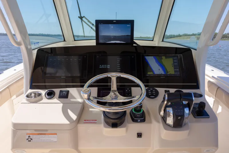 Slide: The Image of 2019 Scout 355 LXF boat helm with advanced navigation displays and controls. - 21