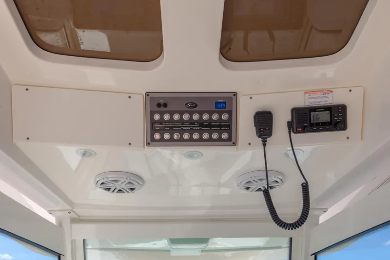 Slide: The Image of 2019 Scout 355 LXF boat dashboard with control panel and communication devices. - 22