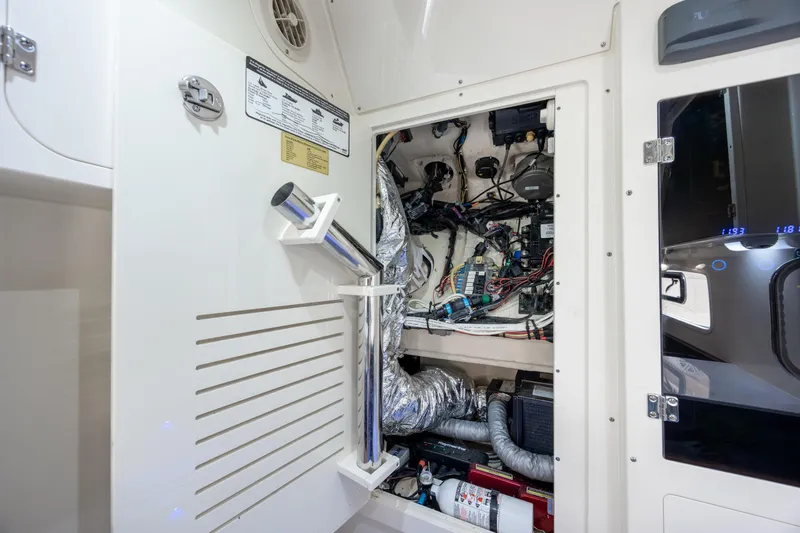 Slide: The Image of Engine compartment of a 2019 Scout 355 LXF boat, showcasing wiring and components. - 43