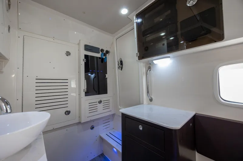 Slide: The Image of Interior of 2019 Scout 355 LXF boat featuring modern cabinetry and sleek design elements. - 39