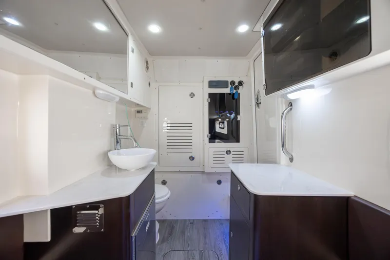 Slide: The Image of Luxurious interior of 2019 Scout 355 LXF boat featuring modern bathroom amenities. - 37