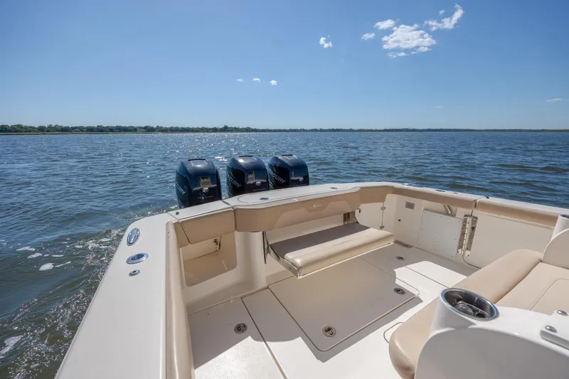 Slide: The Image of 2019 Scout 355 LXF boat with triple engines on open water. - 9