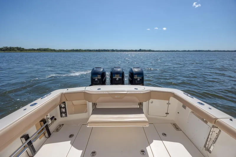 Slide: The Image of 2019 Scout 355 LXF boat with triple engines on open water. - 10