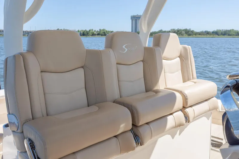 Slide: The Image of Luxurious seating on a 2019 Scout 355 LXF boat, featuring beige leather upholstery. - 24