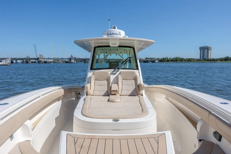 Slide: The Image of 2019 Scout 355 LXF boat on water, featuring Garmin equipment and luxurious seating. - 33