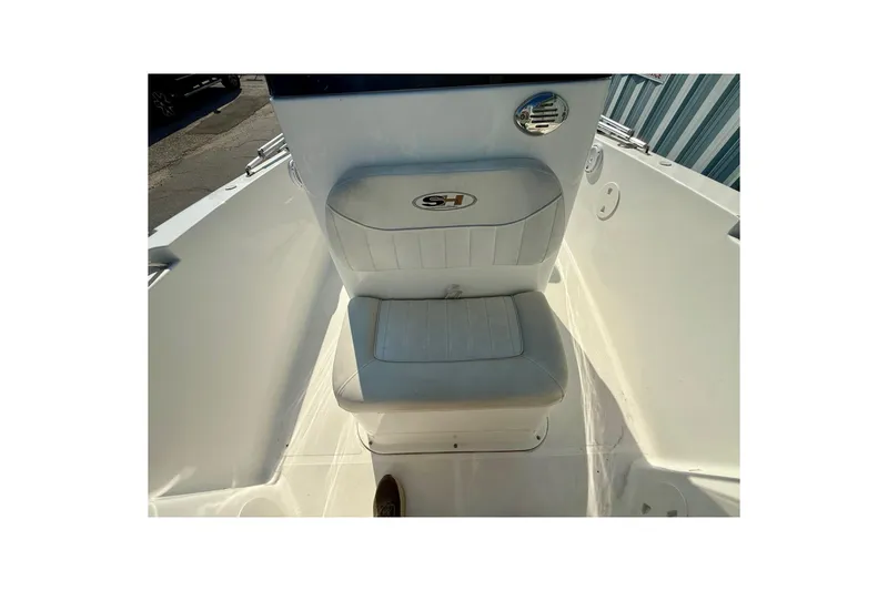 Slide: The Image of 2012 Sea Hunt Triton 210 boat seat with logo, white upholstery, and sleek design. - 8