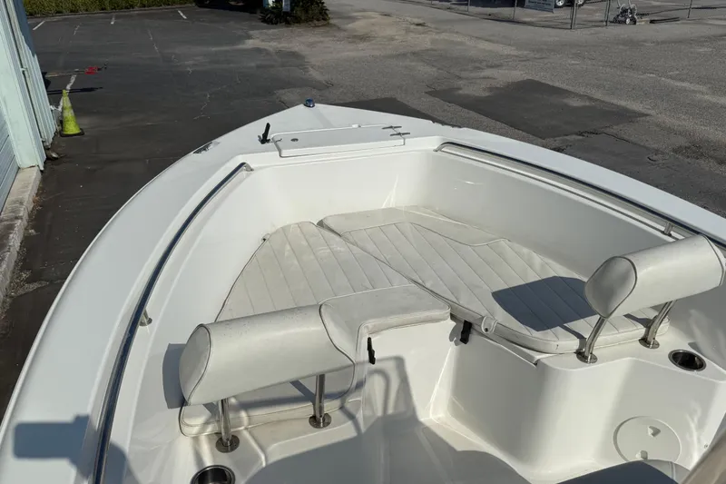 Slide: The Image of 2012 Sea Hunt Triton 210 boat interior with white seating and clean deck. - 7