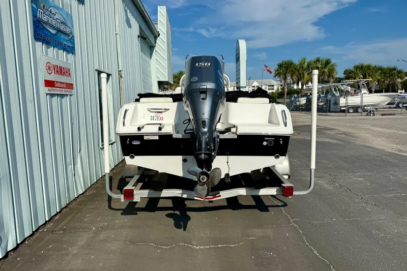 Slide: The Image of 2012 Sea Hunt Triton 210 boat on trailer, parked outside marine service center. - 4