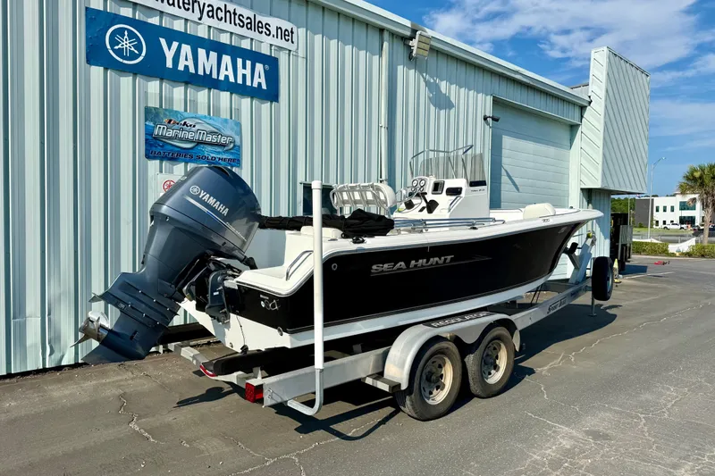 Slide: The Image of 2012 Sea Hunt Triton 210 boat on trailer, parked outside Yamaha dealership. - 2