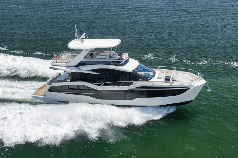 Slide: The Image of Luxury 2022 Galeon 560 Fly yacht cruising on open water. - 4