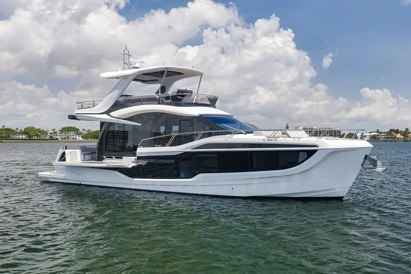 Slide: The Image of 2022 Galeon 560 Fly yacht on water under a partly cloudy sky. - 11
