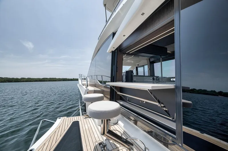 Slide: The Image of Galeon 560 Fly 2022 yacht with sleek design and luxurious outdoor seating. - 90