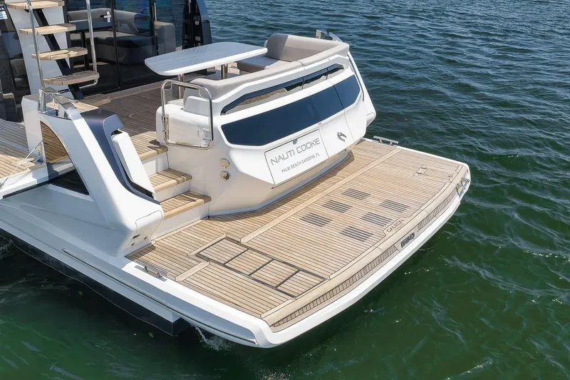 Slide: The Image of Luxury 2022 Galeon 560 Fly yacht with spacious teak deck on water. - 17