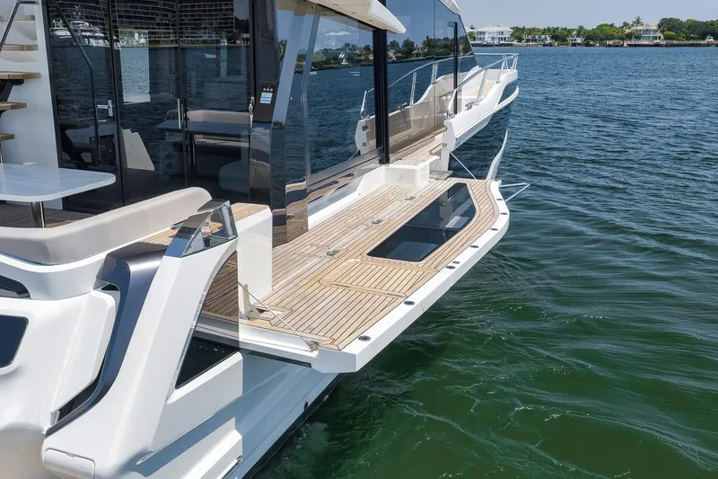 Slide: The Image of Luxury Galeon 560 Fly yacht, 2022 model, featuring sleek design and spacious deck on the water. - 21