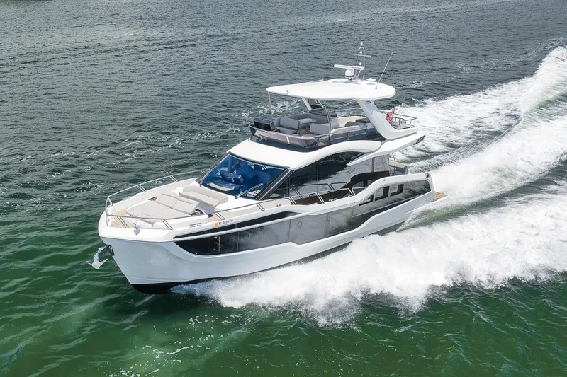 Slide: The Image of 2022 Galeon 560 Fly yacht cruising on open water. - 2