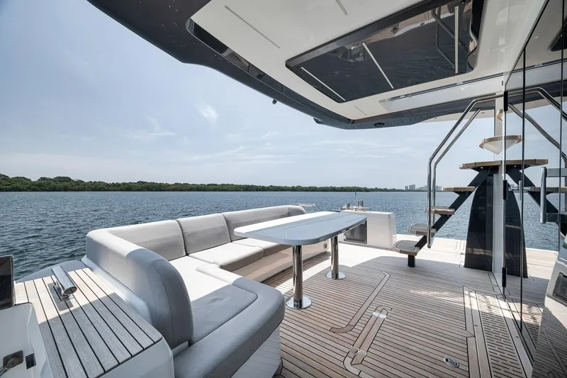 Slide: The Image of Luxurious 2022 Galeon 560 Fly yacht deck with elegant seating and scenic water view. - 92