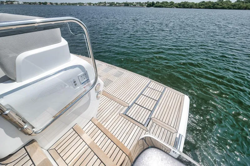 Slide: The Image of Luxury Galeon 560 Fly yacht deck overlooking serene water, 2022 model. - 94