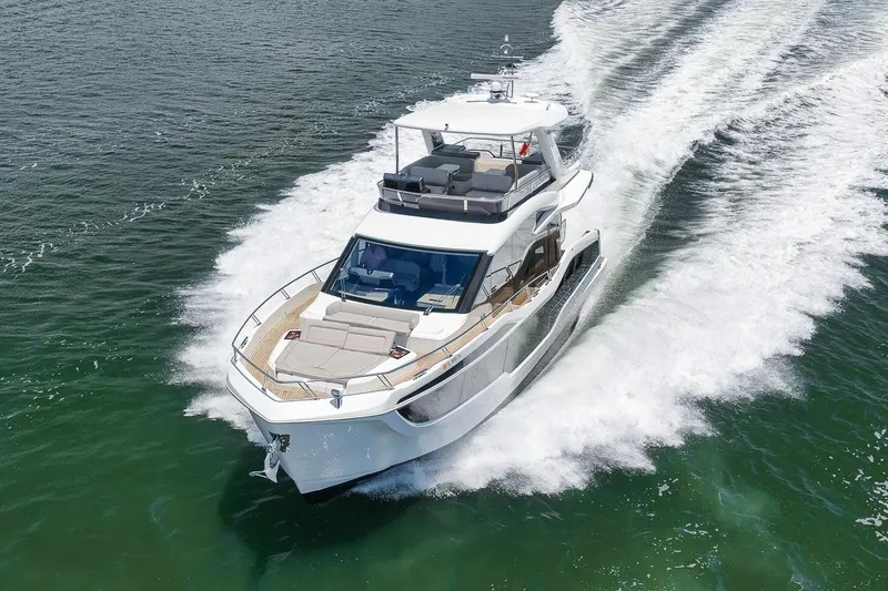 Slide: The Image of Luxury 2022 Galeon 560 Fly yacht cruising on open water, showcasing sleek design and elegance. - 3