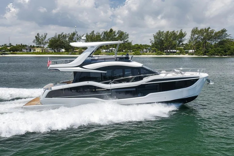 Slide: The Image of 2022 Galeon 560 Fly yacht cruising on a sunny day, showcasing sleek design and luxury. - 7