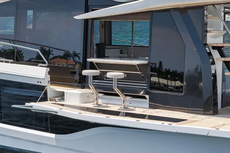 Slide: The Image of 2022 Galeon 560 Fly yacht with sleek design and modern outdoor seating. - 27