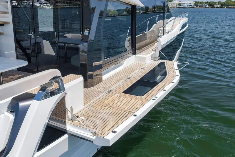 Slide: The Image of 2022 Galeon 560 Fly yacht with sleek deck design on calm water. - 22