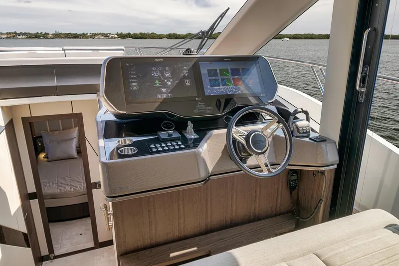 Slide: The Image of Helm of 2022 Galeon 560 Fly yacht with modern navigation controls and steering wheel. - 35