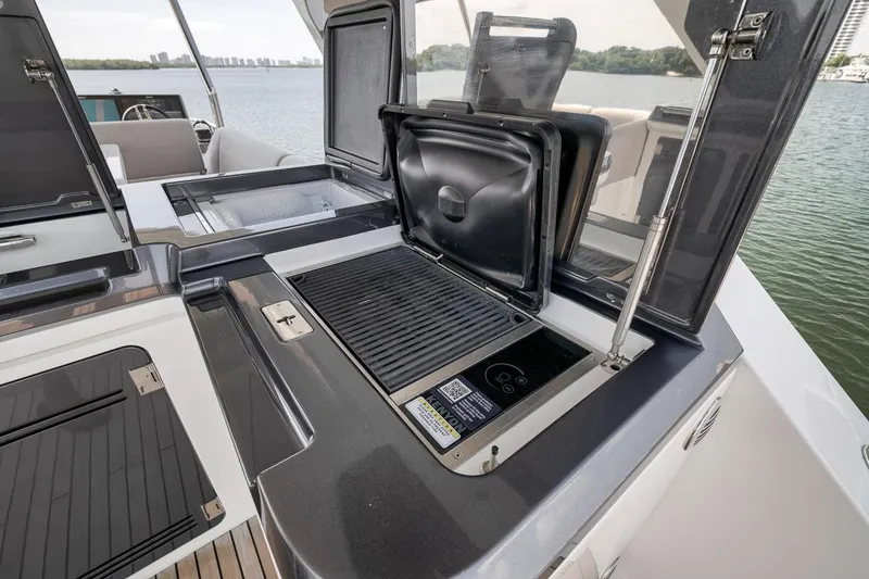 Slide: The Image of Outdoor kitchen on 2022 Galeon 560 Fly yacht with grill and scenic water view. - 80