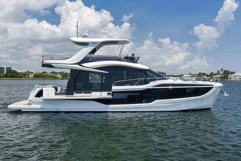 Slide: The Image of 2022 Galeon 560 Fly yacht on calm water under a partly cloudy sky. - 8