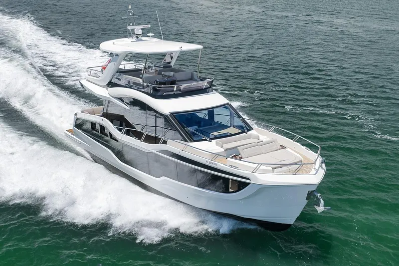 Slide: The Image of 2022 Galeon 560 Fly yacht cruising on open water, showcasing sleek design and luxury features. - 5