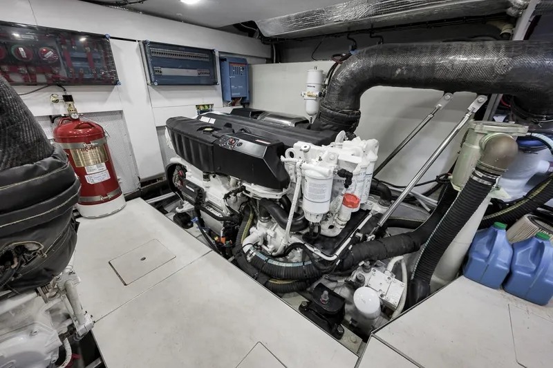 Slide: The Image of Engine room of 2022 Galeon 560 Fly yacht, featuring modern equipment and fire extinguisher. - 100
