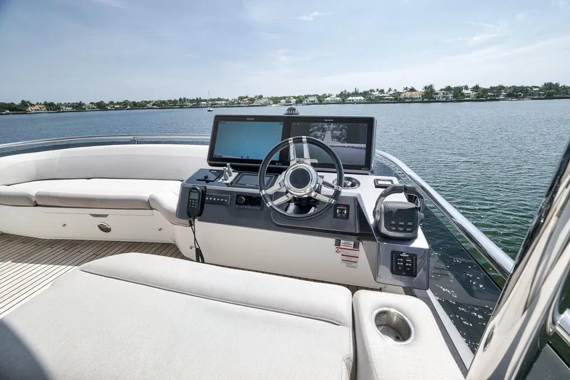 Slide: The Image of Helm of 2022 Galeon 560 Fly yacht with modern controls and scenic water view. - 66