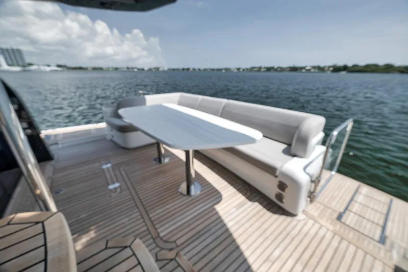 Slide: The Image of Luxury deck seating on 2022 Galeon 560 Fly yacht, overlooking serene waters. - 93