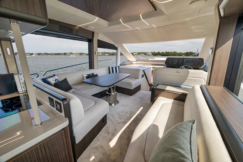 Slide: The Image of Luxurious interior of 2022 Galeon 560 Fly yacht with elegant seating and panoramic windows. - 36