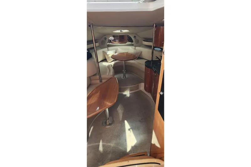 Slide: The Image of Interior of a 2006 Doral Elegante boat with plush seating and wooden tables. - 6