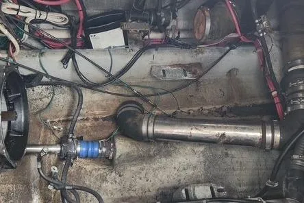 Slide: The Image of Engine compartment of a 2006 Doral Elegante boat with visible wiring and components. - 16